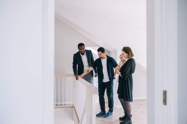 istock Real Estate AGent showing potential new home to clients 1461010148