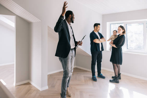 istock Real Estate AGent showing potential new home to clients 1461010161