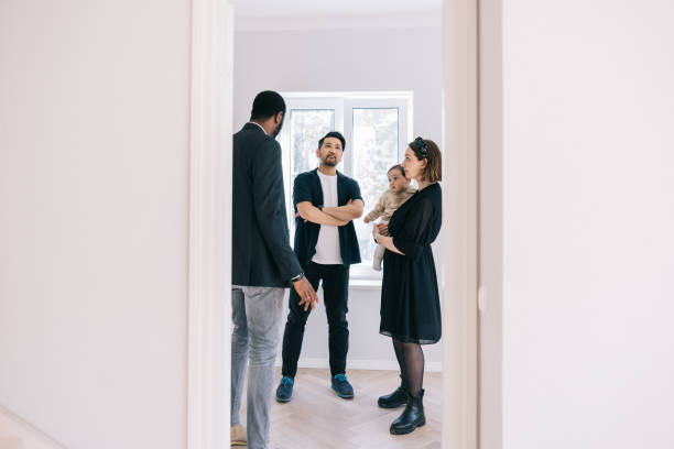 istock Real Estate AGent showing potential new home to clients 1461010186