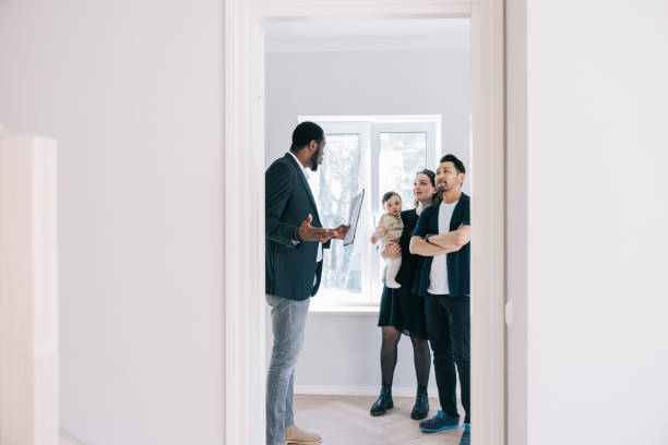 istock Real Estate AGent showing potential new home to clients 1461010207