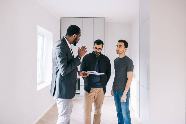 istock Real Estate AGent and couple going through real estate contract 1461010672