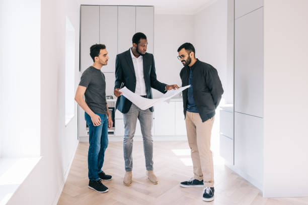 istock Real Estate AGent showing building plans to potential clients 1461010798