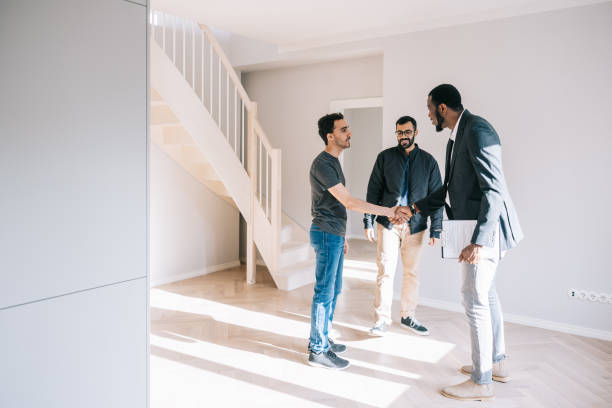 istock Real Estate AGent greeting couple on open house day 1461010900