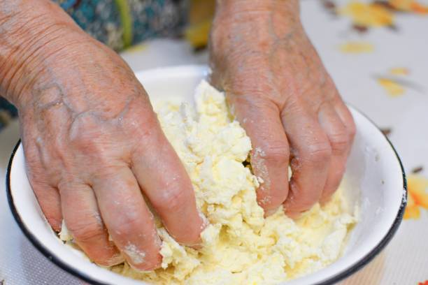 istock Hands mixing dough in a bowl to make dinner 1461011434