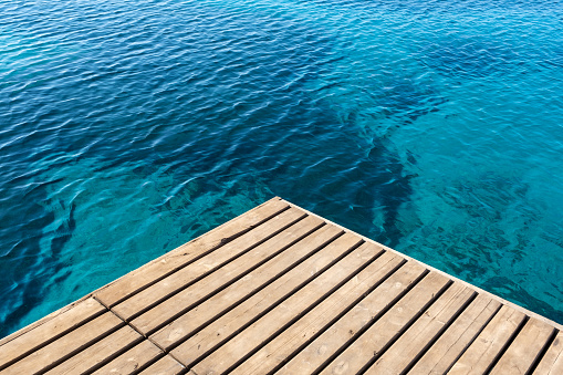 A beautiful view of a wooden dock by the sea