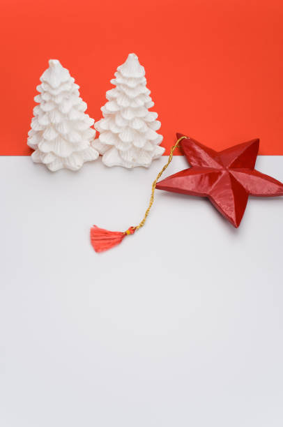 istock decorative Xmas wax fir trees on a white red background with space for text 1461012988