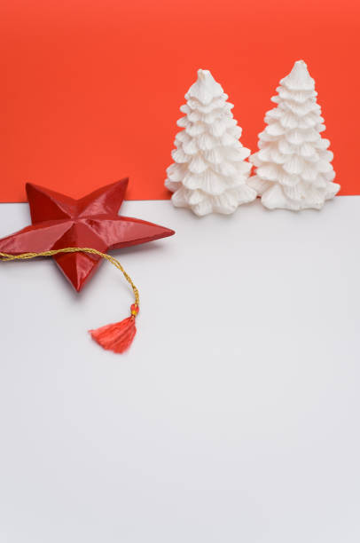 istock decorative Xmas wax fir trees on a white red background with space for text 1461012993