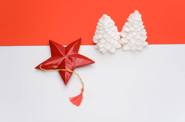 istock decorative Xmas wax fir trees on a white red background with space for text 1461012995
