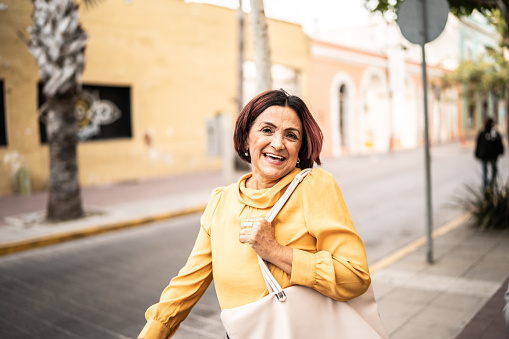 Portrait of senior woman walking at the historic district