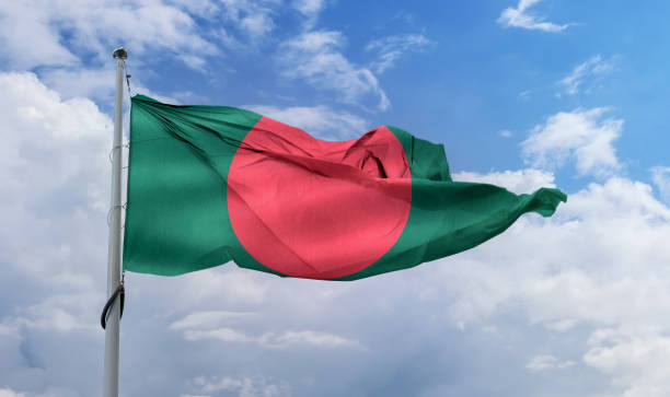 istock Bangladesh flag waving on a pole in a blue sky 1461018473