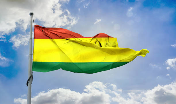 istock Bolivian flag waving on a pole in a blue sky 1461018486