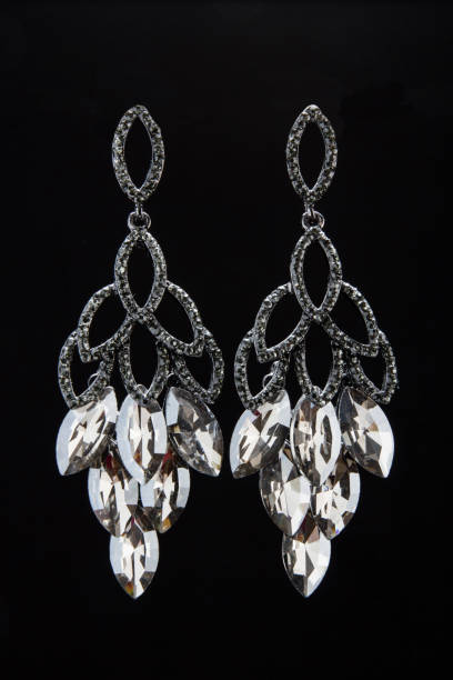 istock Vertical shot of elegant earrings on the black background 1461020123