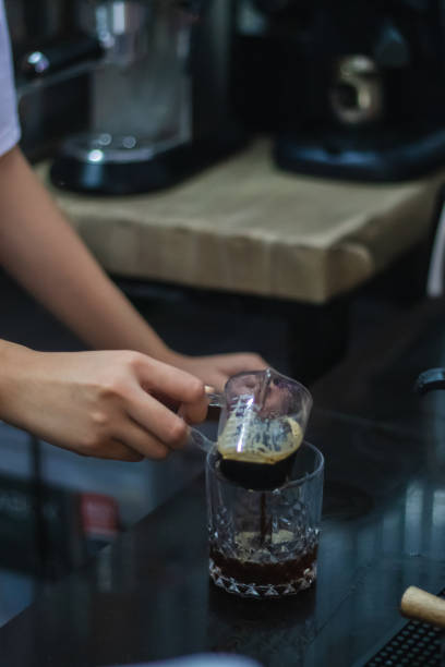 istock Vertical shot of a female making coffee in a cafe 1461020751