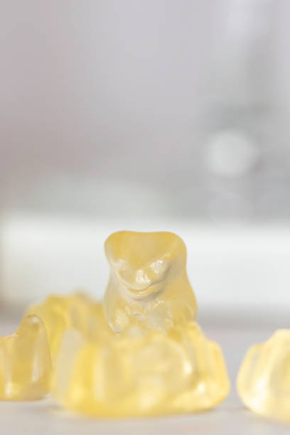 istock Vertical shot of delicious yellow gummies on the white surface 1461021648