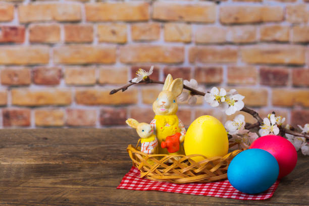 istock Background with funny rabbits, colorful eggs, and a blossomed branch 1461026108
