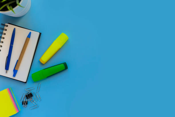 istock Flat lay of workspace desk on blue background with copy space 1461026285