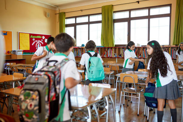 istock School children arriving in elementary classroom 1461028300