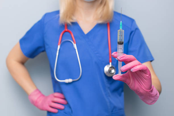 doctor holding a syringe with medicine in his hand. doctor holding a syringe. doctor makes an injection