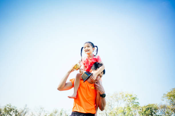 istock Father and daughter celebrating with trophy in hands 1461033145