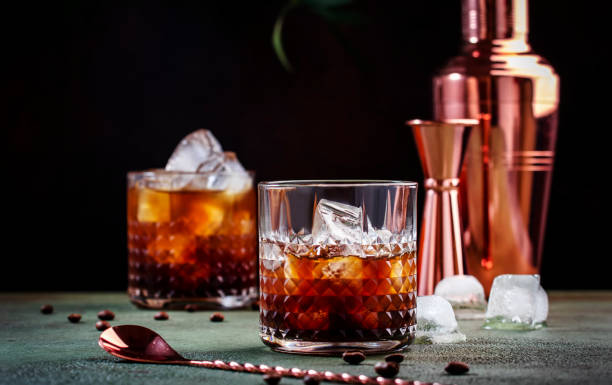 black russian cocktail, alcoholic drink with vodka, coffee liqueur and ice, rusty green background, bar tools, copy space - hard liqueur imagens e fotografias de stock