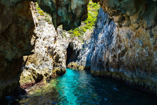 istock Grotto with crystal clear blue, turquoise, tropical waters and a rugged, overgrown coastline that gives a wonderful play of colors, Zakynthos, Greece 1461036406