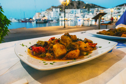 Ratatouille, Greek briam, healthy vegetable summer food on a plate in restaurant with a view