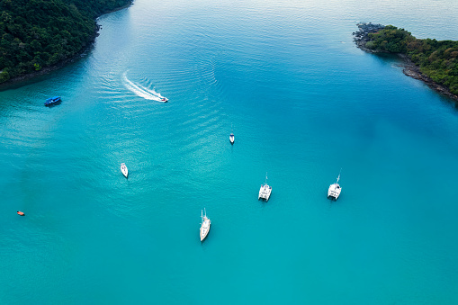 Aerial view of yacht sightseeing sailing on tropical sea in summer vacation at sunny day. Leisure activities and Recreational pursuit