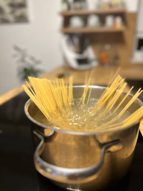 istock Cooking spaghetti in a pot with hot boiling water 1461041559