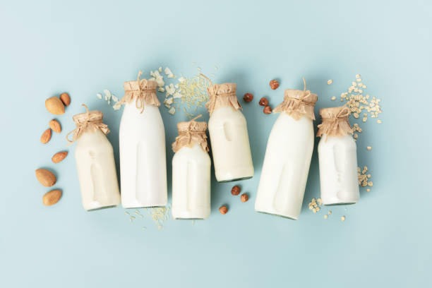 istock on dairy plant based milk in bottles and ingredients on turquoise background. Alternative lactose free milk substitute, flat lay 1461042221