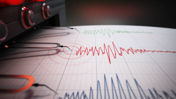 Seismograph printing seismic activity records of a severe earthquake stock photo