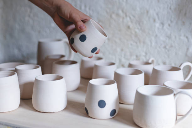 istock Woman examing her clay pots 1461044362