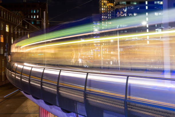 blurred moving train at night in the city,colorful abstract high speed curved movement toward to the future , just around the corner, concept.