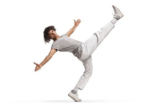 African american young male dancer with leg up isolated on white background