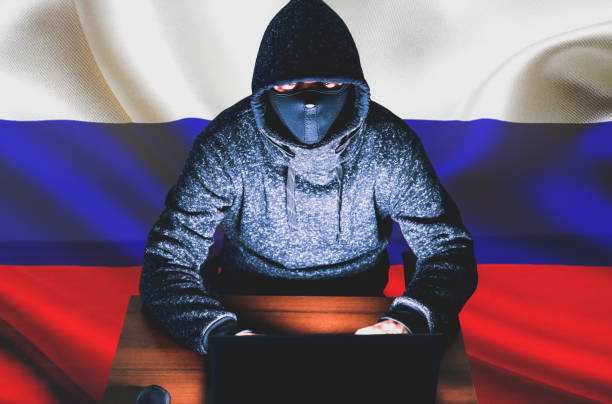 istock Man in hoodie is hacking personal data. Information security with Russian flag. Protection of information concept. Bad password. 1461050379