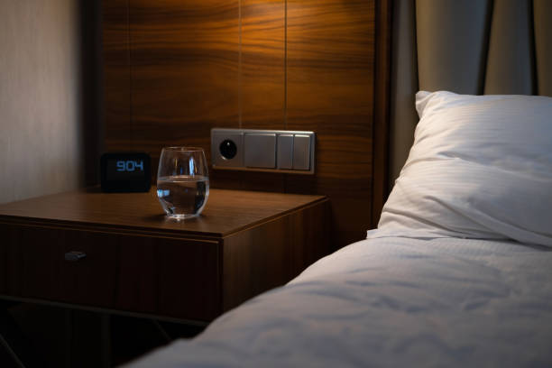 istock Hotel room with a comfortable bed, clock and modern decoration 1461051443