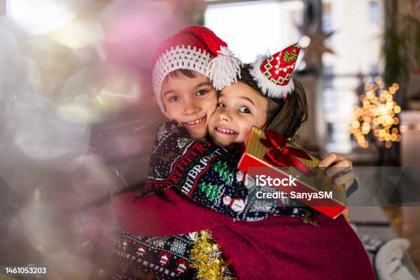 Happy Children On Christmas Eve Stock Photo - Download Image Now - Affectionate, Beautiful People, Beauty