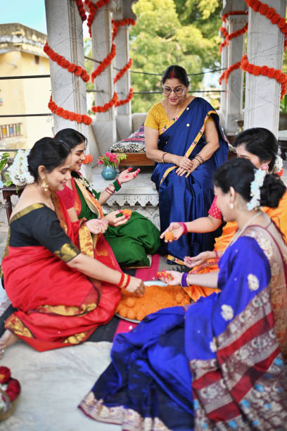 istock Indian women having fun while making Indian sweet (motichur) laddoos 1461053331