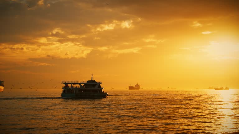 SLO MO A ship sails across the ocean towards the sunset