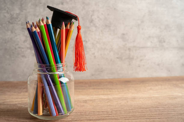 istock Pencils with graduation hat in glass, education learning concept. 1461057444