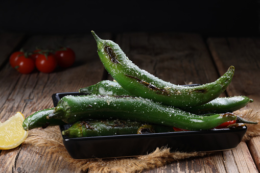 Fried green peppers on pan