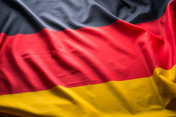 The national flag of Germany with fabric texture waving in the wind
