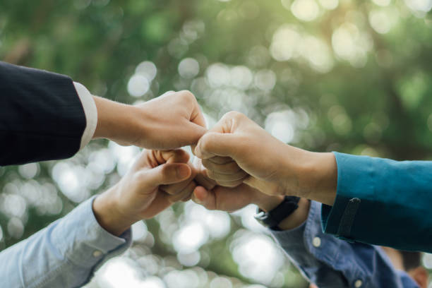 istock Business people join hands after meeting.World environment day. Global community teamwork.Volunteer charity work. 1461062926