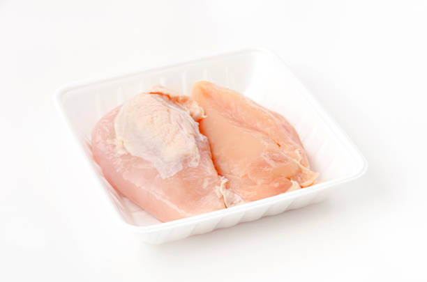 istock Raw Chicken breast on a foam tray on a white background 1461063462