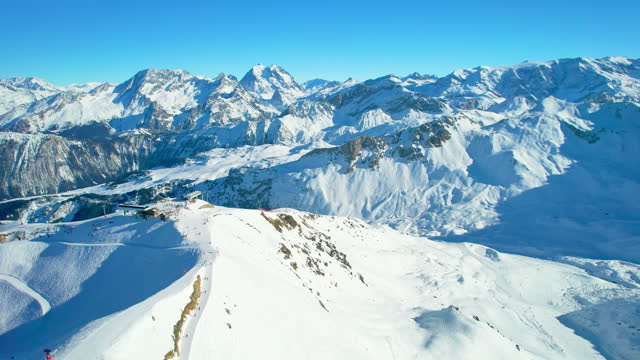Courchevel, France: Aerial view of famous ski resort in French Alps (Savoie Alps) mountains in winter, sunny day with lot of snow - landscape panorama of Europe from above