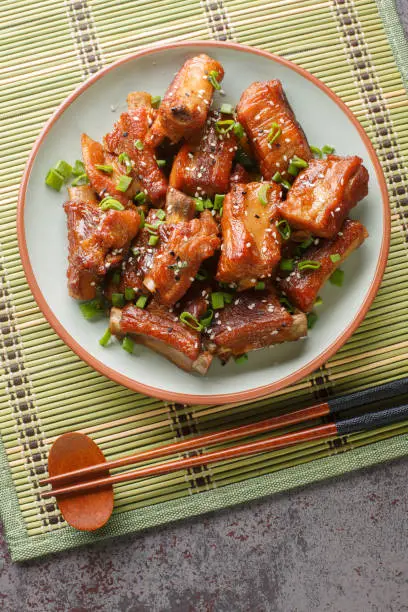 Photo of Sweet and Sour Rib Tang Cu Pai Gu is a quite popular dish in China close-up in a plate. Vertical top view