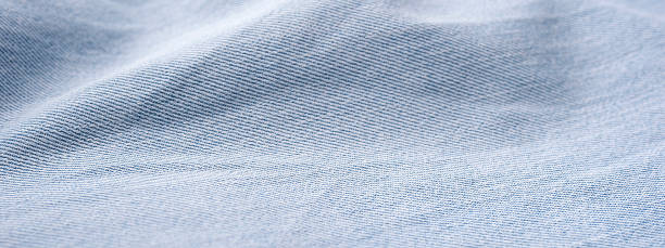 istock Jeans background Perspective and closeup view to abstract space of empty light blue natural clean denim texture for the traditional business background. 1461065206
