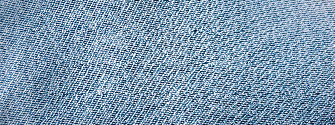 Jeans background Closeup view to abstract space of empty light blue natural clean denim texture for the traditional business background.