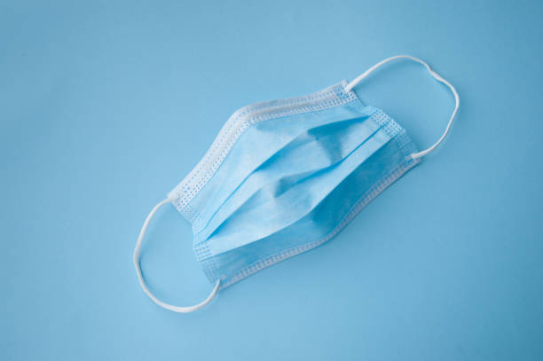 istock blue medical mask on background 1461066615