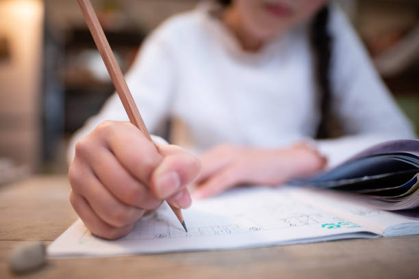 istock Hand of a child studying at home 1461066638