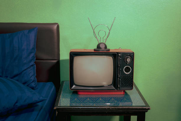 istock Red retro old TV with antenna on table in the bedroom. 1461067307